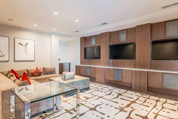 a living room with a couch and a glass table at The Acadia at Metropolitan Park, Arlington, Virginia